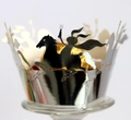Macro detail of laser-cut silver cupcake wrapper with hero horse silhouette design - Reflective Silver