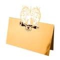 Macro detail of laser cut gold place card featuring intricate bird and floral patterns - Reflective Gold