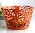 Macro shot of orange laser-cut cupcake wrappers with elegant vine and scroll patterns - 5cm / Orange Red