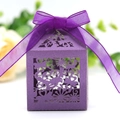 Close-up of purple laser-cut wedding favor box with floral patterns and satin ribbon - Dark Purple