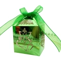 Detail of green metallic candy box featuring intricate Ganesha hollow-out carving and ribbon - Reflective Green