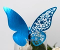 Detail of blue laser-cut butterfly place card with floral patterns on glass rim - Reflective Blue