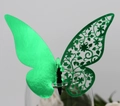 Detail of green 3D butterfly place card with laser-cut floral texture on a glass rim - Reflective Green