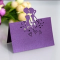 Purple laser-cut place card with kissing couple silhouette and heart cutout design - Dark Purple