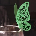 Detail of green laser-cut butterfly place card with intricate floral镂空 patterns on wine glass - Dark Green
