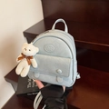 Light blue mini backpack with crinkle texture leather and white plush bear charm - Blue