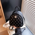 Mini black quilted backpack featuring a rhinestone star and studded diamond accents - Black
