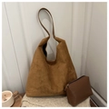 Close-up of retro suede tote bag and matching clutch on a soft knit blanket - Simple Style / Brown
