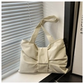 Detailed view of cream-colored bow knot design on minimalist nylon tote bag with wide strap - White