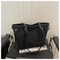 Detailed side view of black matte tote bag with slim shoulder strap on modern black chair - Black Without Pendant