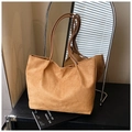Detail shot of brown suede tote bag with slim handles and matte leather texture - Brown