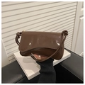 Detail of dark brown glossy patent leather shoulder bag with gold metal buckle and knot strap - Brown