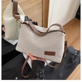 Woven dumpling bag in cream and brown leather finish with adjustable shoulder strap - Coffee
