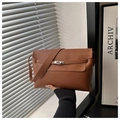 Close-up of brown leather bag with silver metal turn-lock and flap detail - Brown