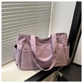 Detail der lavendelfarbenen Nylon-Tragetasche mit Seitentaschen und Fashion-Label am Fenster - Lila