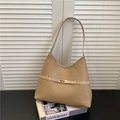 Chic khaki woven textured shoulder bag with golden lock on stylish magazines background - Khaki