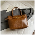 Detailed view of the brown vintage tote bag featuring a gold buckle and premium leather texture - No Pendant / Brown