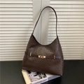 Vintage dark brown woven hobo bag with gold buckle on luxury fashion magazines - Coffee