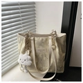 Close-up of beige canvas tote with star moon prints and gold chain metal handles - Yellow With Cloud Charm