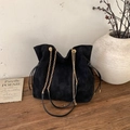 Detail of black suede bucket bag with gold chain strap on vintage wooden surface - No Pendant / Black