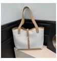 Detailed view of woven texture tote bag with khaki leather trim and gold metal buckle - White & Khaki