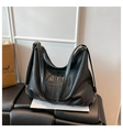 Detail view of large black vintage hobo bag with textured PU leather and round embossing - Black
