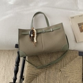 Sage green woven tote bag with adjustable leather straps and beaded charm detail - Green With Pendant