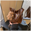 Dark brown leather bucket bag with metallic chain, side drawstrings and plush bear charm - Brown with Pendant