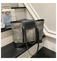 Détail du sac cabas bicolore montrant la texture toile et les finitions cuir en scène - Noir