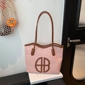 Pink woven tote bag with brown leather trim and circular AB logo for daily commuting - Pink