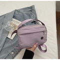 Detail of purple nylon crossbody bag with metal logo and contrast shoulder strap - Purple