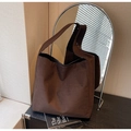 Close-up of a large brown suede tote bag on a desk with a stylish arched mirror - Coffee