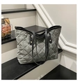 Detail of grey quilted tote bag featuring gold rivets and durable fabric texture - Gray