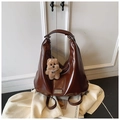 Fashionable dark brown glossy leather Hobo bag with a plush puppy charm and metal logo - Coffee with Pendant