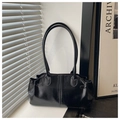 Detalle de bolso tote de cuero sintético negro brillante con hebillas y costura central - Negro