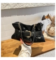 Fashionable black pleated tote bag with golden buckle and chain strap on table - Black