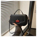 Detail of matte black crossbody bag featuring unique 3D red cherry embellishment - Black