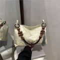 New Chinese style shoulder bag with bead handle and traditional landscape pattern - Yellow