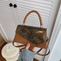 Caramel brown patchwork handbag with snakeskin texture and sleek cylindrical handle - Brown