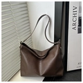 Detail of soft dark brown leather tote bag with elegant shadow on a minimalist background - Coffee Without Pendant