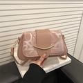 Pink faux leather shoulder bag with abstract letter prints and gold crescent buckle - Pink