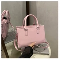 Pink tote bag with vertical texture and adjustable shoulder strap on a white surface - Pink