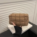 Quilted brown puffer makeup bag with soft padded texture and zipper for travel storage - Brown