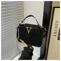 Detail of black suede trapezoid handbag with gold V metal logo and shoulder strap - Black