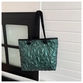 Detail of green metallic quilted tote bag with star stitching and black rope handles - Green