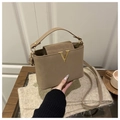 Light brown crossbody bucket bag with gold V-buckle and contrasting leather textures - Khaki
