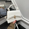 White structured handbag with twisted knot handle and golden metal clasp closure - White