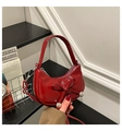 Detail der roten Lackleder-Halbmondtasche mit Schleife und silbernen Metallkugeln - Rot
