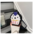 Macro detail of cupcake shaped crossbody bag with lychee texture and blue strap - Black