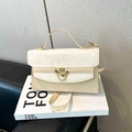 Elegant cream crossbody bag with gold buckle and marble texture shown from a high angle - Beige